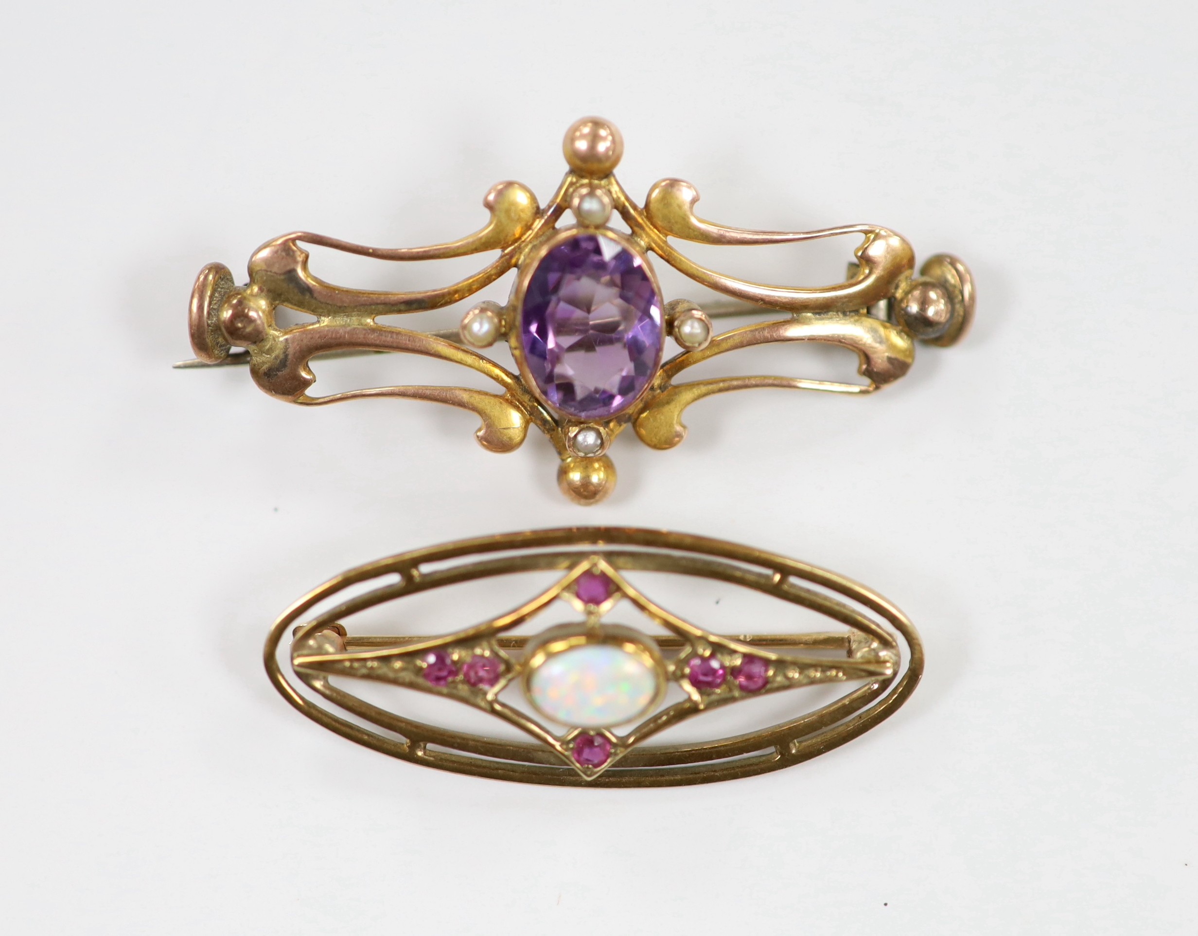 Two early 20th century yellow metal and gem set brooches, including amethyst and seed pearl, 45mm and white opal and ruby, gross weight 8.2 grams.